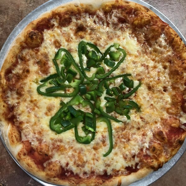 Espresso Pizza's cheese pizza with green bell peppers arranged in a shamrock shape.