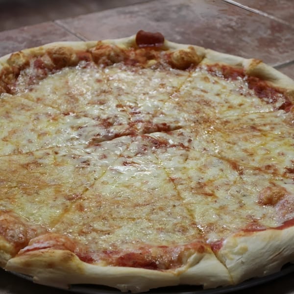 A freshly baked, sliced cheese pizza from Espresso Pizza with a golden crust and melted mozzarella.